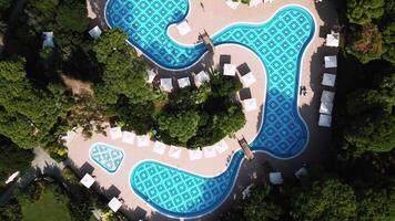 Aerial View of Curved Swimming Pool with Blue Tile Patterns video