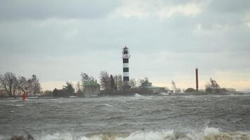 Black and White Lighthouse on Windy Coastal Day with Red Tower video