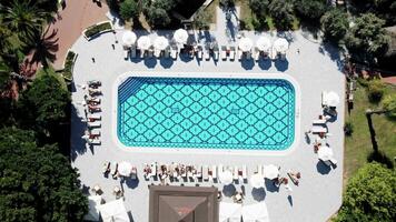 Aerial View of Geometric Patterned Pool with Sun Loungers and Umbrellas video