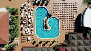 Aerial View of Geometric Pool and Resort with Palm Trees video