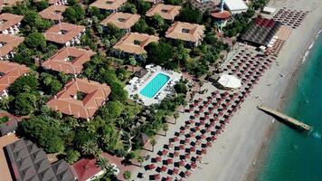 Aerial View of Coastal Resort with Red Roofs and Turquoise Sea video