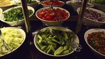 Buffet Style Salad Bar with Fresh Vegetables on Dark Countertop video