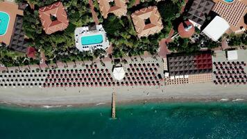 Aerial View of Beachfront Resort with Sun Loungers and Pier video