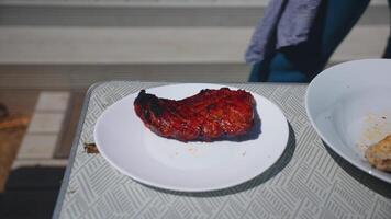 Person Slicing Grilled Meat on Geometric Patterned Table video