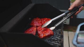 Grilling Marinated Meat on a Deck with Modern Building View video