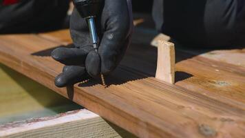 Close Up of Hands Using Power Drill on Wooden Plank in Sunlight video