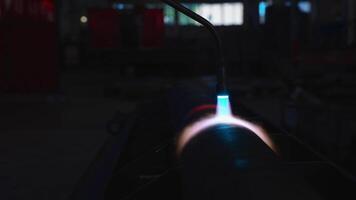Welding Torch with Blue Flame in Industrial Workshop Setting video