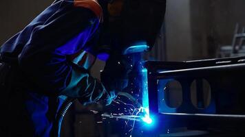 Welder in Protective Gear Operating Torch in Industrial Workshop video