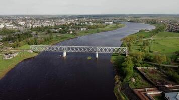 Metal Truss Bridge Over River with Cityscape in Background video