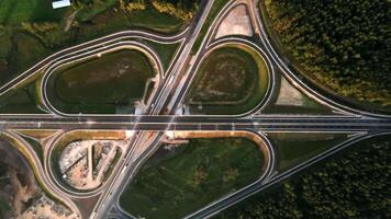 Aerial View of Symmetrical Highway Interchange Amidst Forest and Fields video