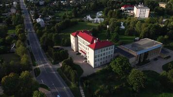 Red Roofed Building in Suburban Setting with Trees and Open Spaces video