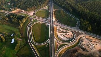 Aerial View of Highway Interchange Amidst Forest and Open Fields video