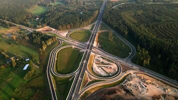 Complex Highway Interchange Amidst Dense Forest and Open Fields video