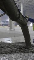 Skilled laborers are actively pouring concrete at a busy construction site for a new project. Clip video