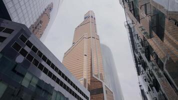 A stunning skyscraper stands tall among the vast and diverse urban architecture of the city. Action video