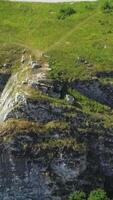 A Magnificent Aerial View of a Rocky Cliff Surrounded by Beautiful and Lush Greenery. Clip video