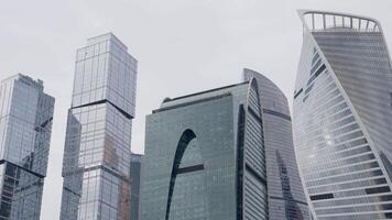 Modern skyscrapers stand tall against a cloudy sky, symbolizing economic activity and innovation. Action video