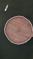 Aerial View of Stunning Circular Pier Surrounded by Boats Floating in Calm, Serene Water. Clip video