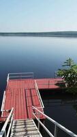 Serene and Beautiful Lakeside View Featuring a Pier Stretched Over Calm and Still Waters. Clip video