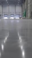 Expansive and Spacious Industrial Warehouse Featuring a Floor with Polished Reflection. Clip video