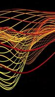 A mesmerizing wave of colorful lines flows on a black background. Design video