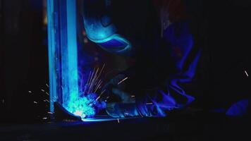 Welder at Work with Blue Light Emanating from Welding Process video