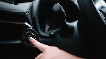 Track in to the button. Off car engine. Finger press the button to start the car engine. Electronic means protection against car theft. Finger of hand presses ignition button car video