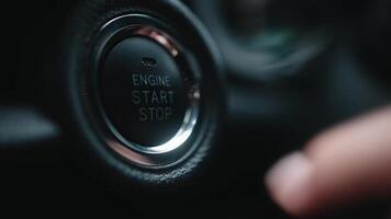 Close-up of finger press pushing start stop button in car. Macro shot, hand starting car with button. Driver using start button in modern car, advertising concept video