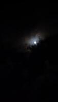 full moon in the night sky above high-rise buildings illuminated by lanterns video