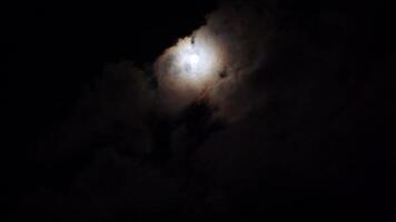 full moon in the night sky above high-rise buildings illuminated by lanterns video