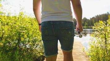 Person on Wooden Dock Overlooking Calm Lake with Lily Pads video