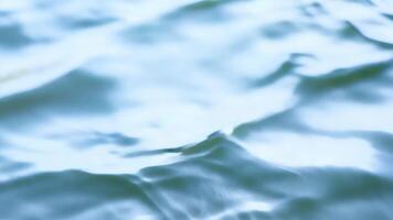 Blurred water ripples with soft blue light reflections. Abstract aquatic background. video