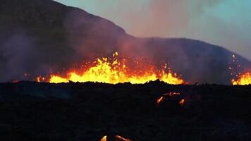 Lava flows from a volcano in the middle of a field video
