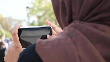 Capturing Moments. A Person Taking Photos Outdoors with Smartphone video