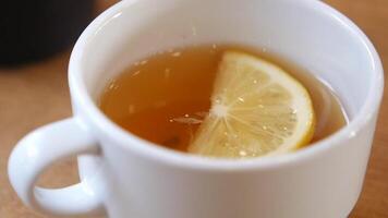 A warm cup of tea infused with fresh lemon for refreshing enjoyment video