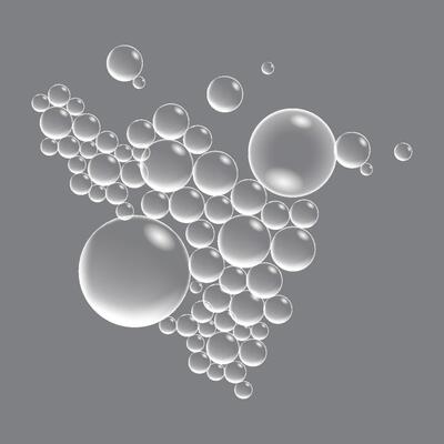 Soap bubbles, displaying unique designs, gracefully float on a plain gray surface
