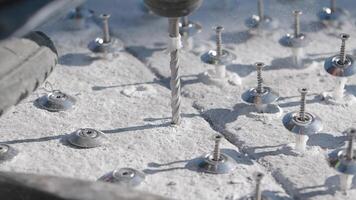 Closeup of drilling into concrete with various tools and fasteners video