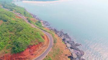 Curve route on hill while ocean waves crashes below video
