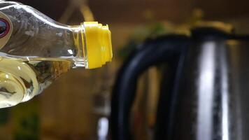 A CloseUp View of an Oil Bottle Positioned with a Kettle in the Background video