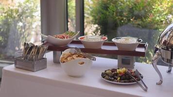 Elegant Buffet Setup with Varied Food Items on Wooden Platform video