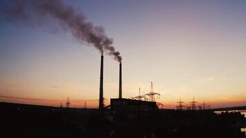 Factory tubes on the sunset background. Smoke from the pipes. Pollution concept. from the air. video