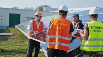 Workers installing solar panels in a sunny day. Sustainable and renewable source of clean energy on a new solar farm. video