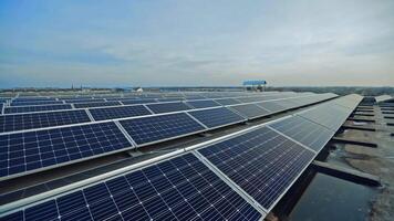 Long rows of blue solar panels. New sunny batteries for renewable energy under the blue sky. Many solar panels arranged in even rows on the roof. video