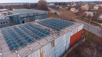 Solar panels installation. View from above on a solar energy farm on the roof of a big building. Renewable source of energy. Aerial view. video