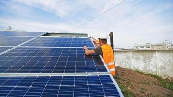 Installation of solar batteries in summer. Workers installing photovoltaic solar panel. Innovative technologies of getting clean electric energy. video