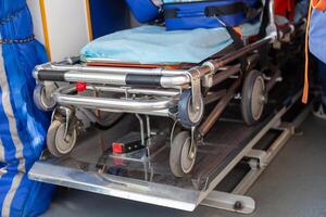 Close-up view of a folded stretcher in the interior of an ambulance photo