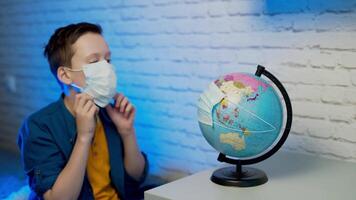 Boy looking at globe learning about virus spreading around the world video