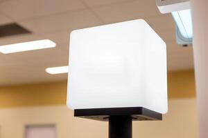 White empty light information cube on the counter, with a place for text photo