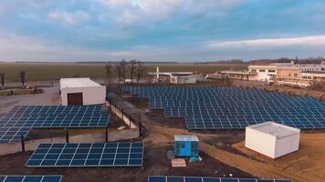 Solar farm on the field. Sunny batteries on the ground among nature. Renewable source of energy. Motion camera back. video