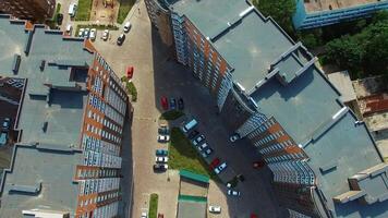 View from above on a modern residential complex. Beautiful design of a car parking and playground near the apartment buildings. Aerial view. video